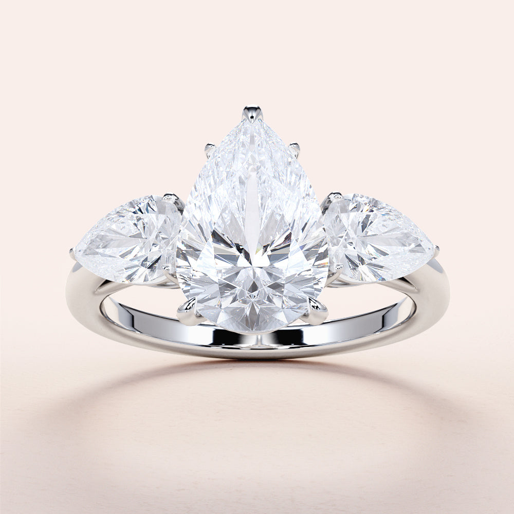 "Elegant pear-shaped diamond engagement ring with side stones, set in 14K or 18K white gold or platinum band."