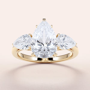 Elegant 14K yellow gold engagement ring with a pear-shaped diamond center and two side pear-shaped diamonds.