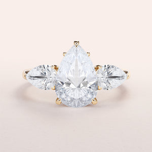 Three-Stone Pear Shaped Diamond Engagement Ring in 14K or 18K Gold or Platinum, featuring side stones for added elegance.