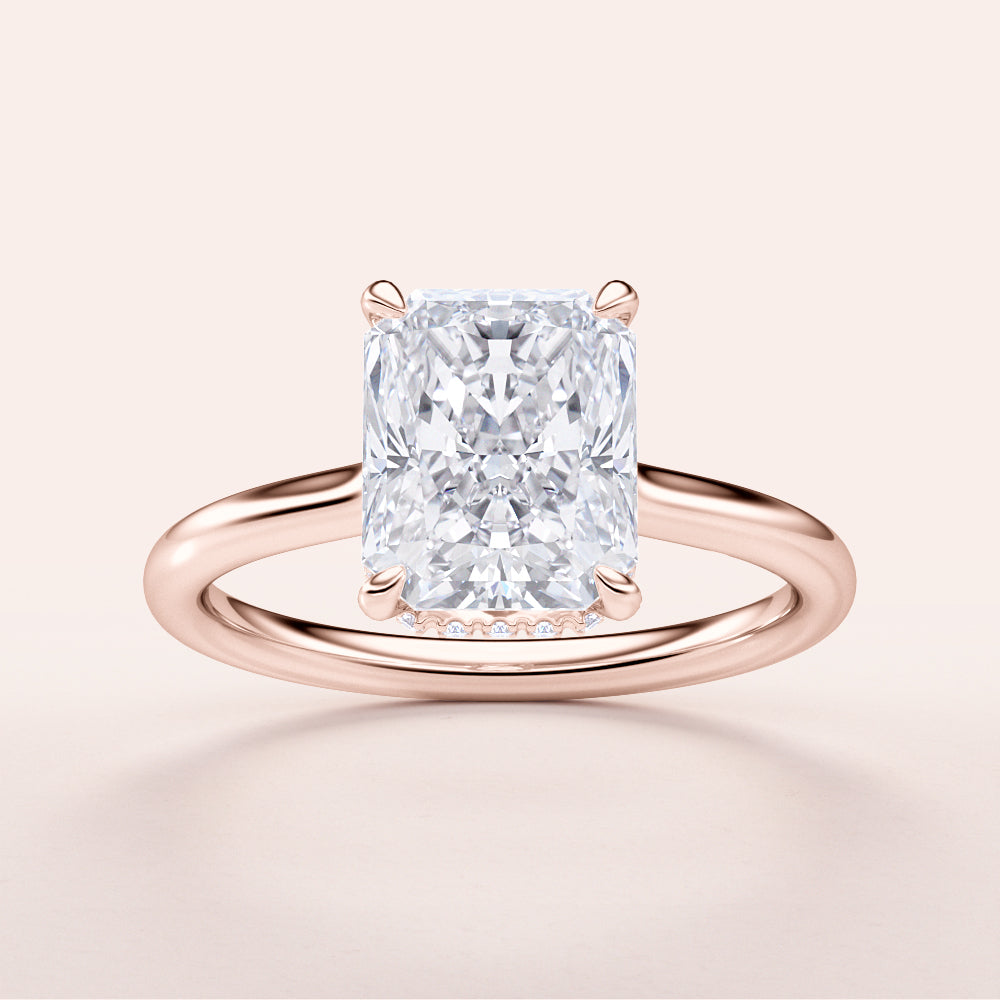 Radiant cut diamond engagement ring in 14K rose gold, featuring a hidden halo and invisible gallery on a plain band.|







#14KRecycledRoseGold
#18KRecycledRoseGold


