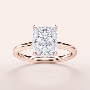 Radiant cut diamond engagement ring in 14K rose gold, featuring a hidden halo and invisible gallery on a plain band.