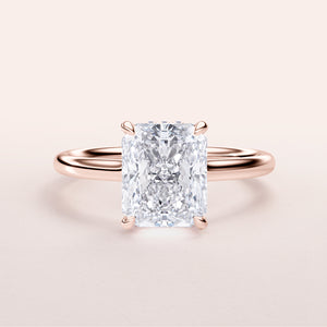 Radiant cut diamond engagement ring in rose gold band, available in 14K, 18K, or platinum. Elegant solitaire, sparkling design.