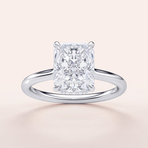 Radiant cut diamond engagement ring in 14K or 18K gold, featuring a sleek band and hidden halo design.