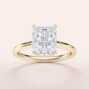 Radiant cut diamond solitaire ring in 14K yellow gold, featuring a hidden halo and an elegant plain band design.