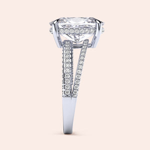 14K white gold engagement ring featuring a cushion hidden halo and split shank design with round diamonds on a plain background.