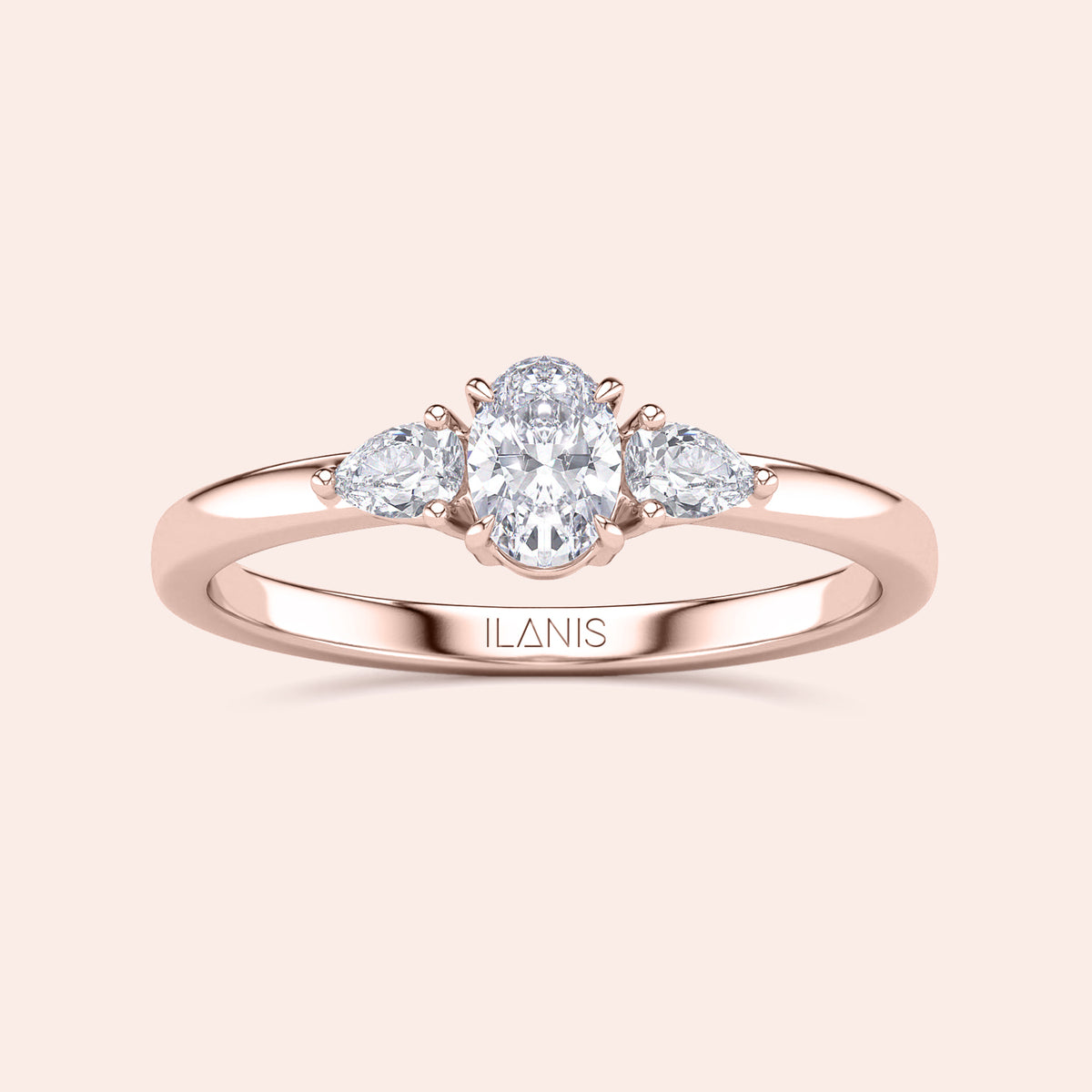 Elegant 14K rose gold engagement ring featuring an oval diamond center and stunning three-stone pear-shaped side diamonds.