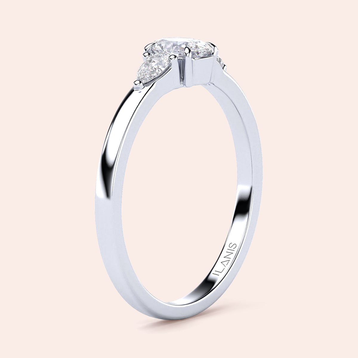 Elegant 14K white gold engagement ring featuring an oval diamond center and two pear-shaped side stones in a three-stone setting.