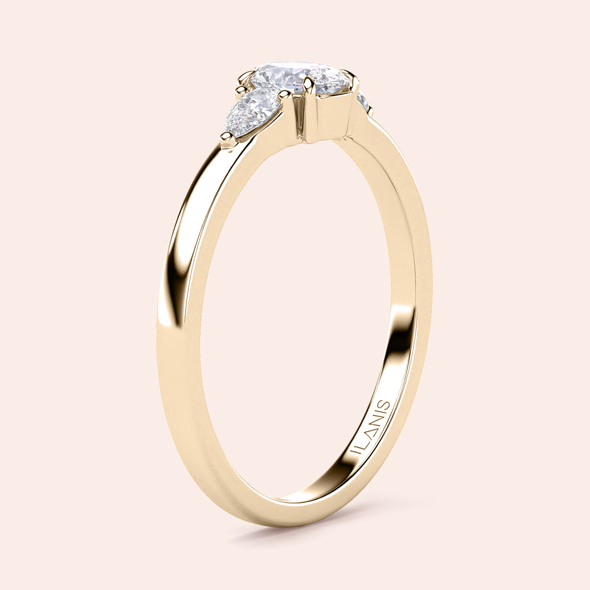 Elegant 14K yellow gold engagement ring with teardrop diamond and side pear stones, perfect for love and commitment.