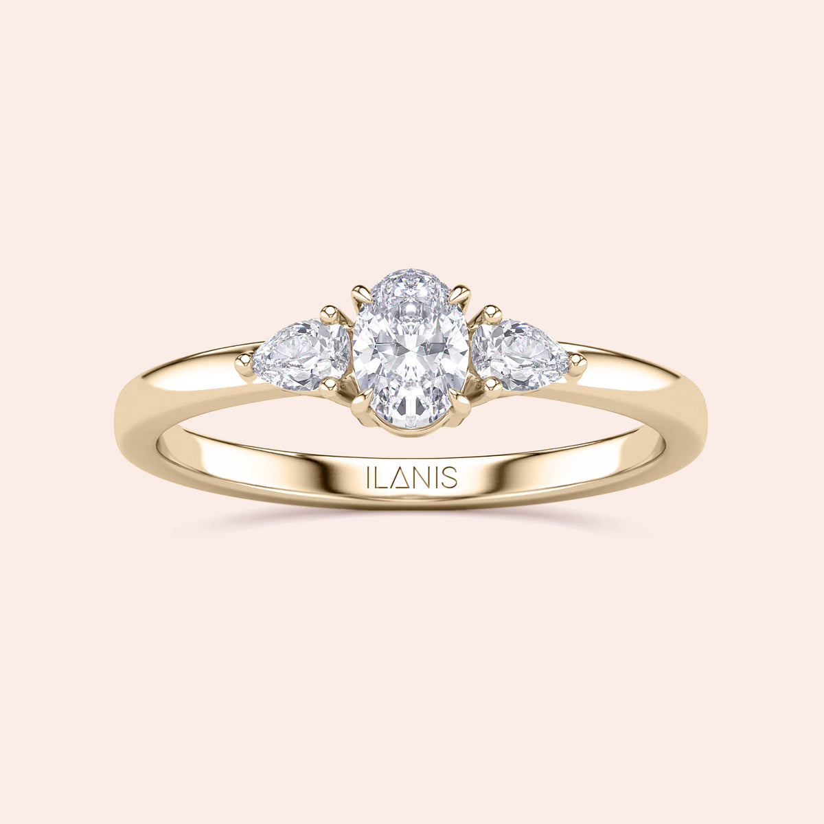 14K gold engagement ring featuring an oval center diamond and two pear-shaped side diamonds, perfect for an elegant touch.