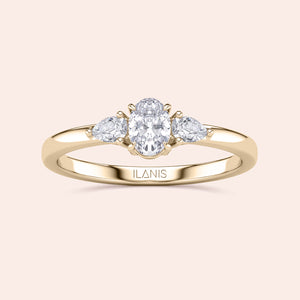 14K gold engagement ring featuring an oval center diamond and two pear-shaped side diamonds, perfect for an elegant touch.