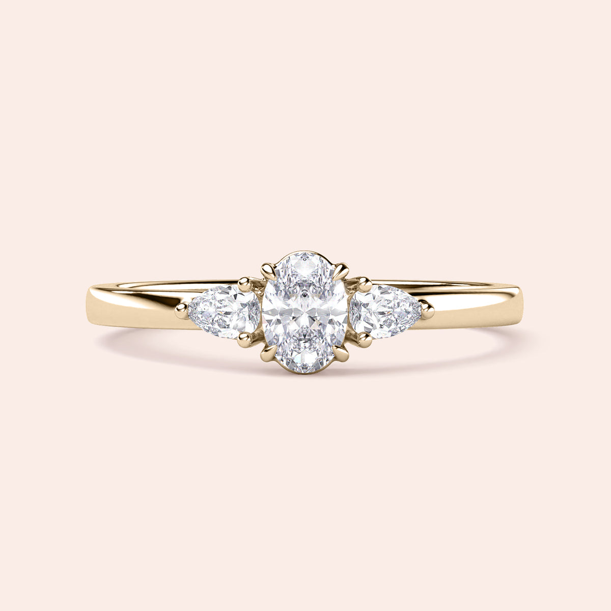Elegant 14K or 18K gold or platinum engagement ring featuring an oval diamond and pear-shaped side stones, ideal for special occasions.