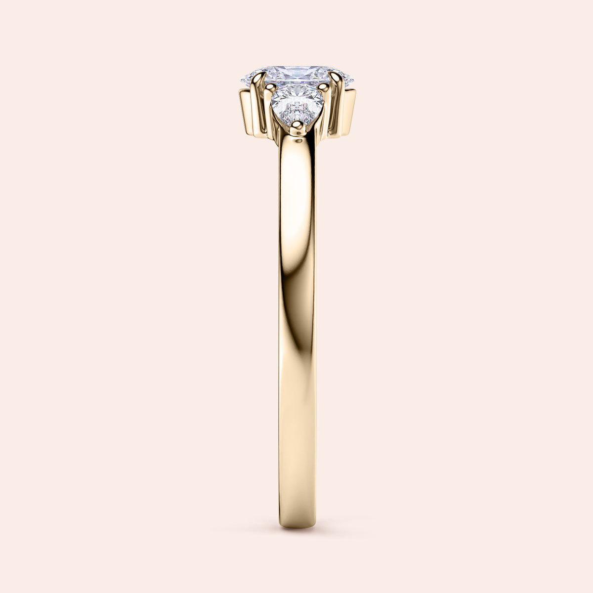 Elegant yellow gold three-stone engagement ring featuring pear stones, available in 14K or 18K gold or platinum setting.