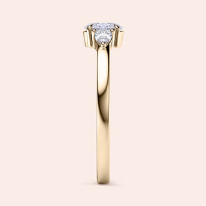 Elegant yellow gold three-stone engagement ring featuring pear stones, available in 14K or 18K gold or platinum setting.