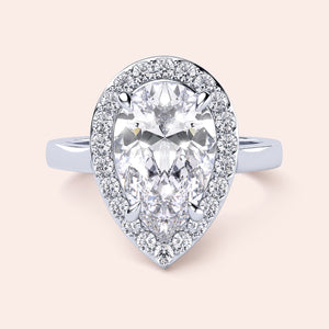 Exquisite pear-shaped diamond engagement ring with halo setting in 14K white gold, showcasing dazzling brilliance.