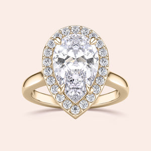 Elegant pear-shaped diamond engagement ring set in 14K or 18K gold, featuring a brilliant halo of smaller diamonds.
