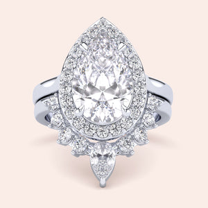 Luxurious pear-shaped diamond engagement ring in 14K/18K gold or platinum, featuring a halo of smaller diamonds for special occasions.