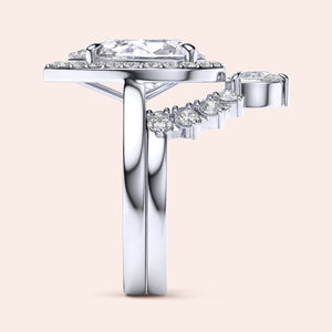Side view of elegant 14K white gold engagement ring with pear halo solitaire and diamond accent band, not worn on model.