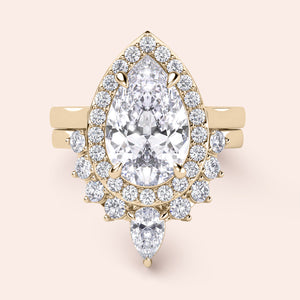 Elegant pear-shaped diamond engagement ring set in 14K or 18K gold, featuring a brilliant halo of smaller diamonds.