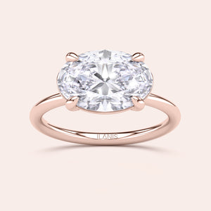 Elegant oval cut diamond engagement ring with rose gold band, available in 14K, 18K, or platinum. Not worn on model.