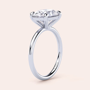 Elegant 14K white gold oval east-west solitaire engagement ring showcasing a radiant round diamond in a classic four-prong setting.