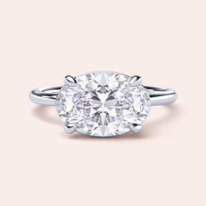 Elegant engagement ring featuring an oval diamond in a polished 14K white gold band, close-up view for jewelry enthusiasts.