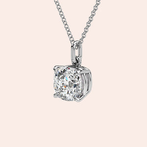 A front-facing view of a cushion-cut solitaire diamond pendant set in a delicate four-prong white gold setting. This classic and elegant design enhances the diamond’s brilliance, making it an iconic jewelry staple for any occasion.