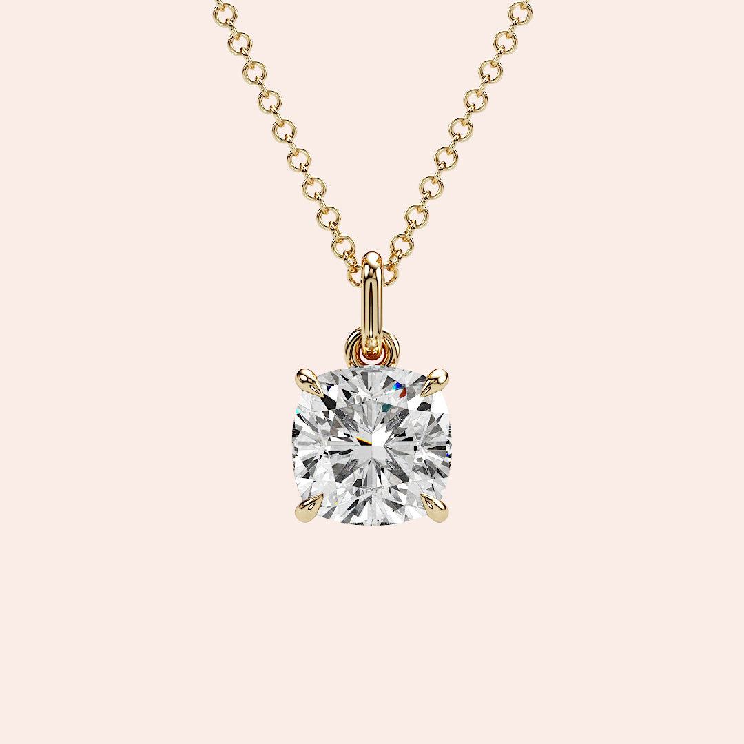 A front-facing view of a cushion-cut solitaire diamond pendant set in a delicate four-prong yellow gold setting. This classic and elegant design enhances the diamond’s brilliance, making it an iconic jewelry staple for any occasion.| 

#14KRecycledYellowGold #18KRecycledYellowGold